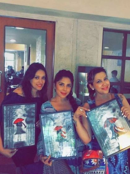 A special Women's Day art party where friends painted this lovely "girl with a red umbrella" theme. It's a celebration of friendship and female creativity.