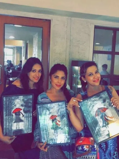 A special Women's Day art party where friends painted this lovely "girl with a red umbrella" theme. It's a celebration of friendship and female creativity.