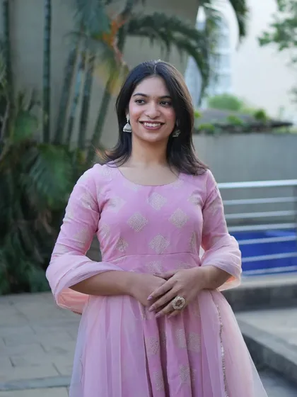 A lovely three-quarter portrait of a woman in a pastel Anarkali, her happy expression making the photo feel warm and inviting.