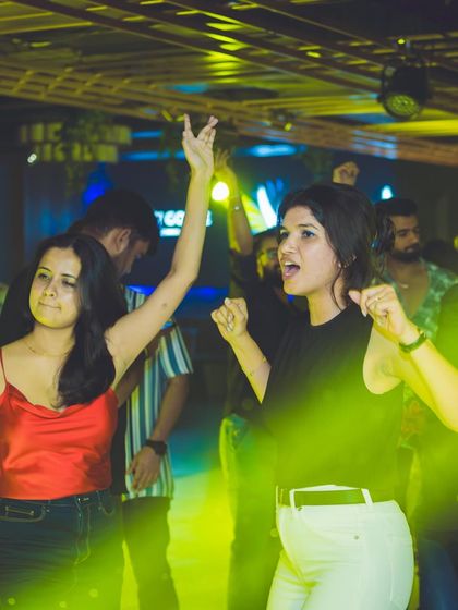 Guests dancing under the yellow lights at Gawky Goose.