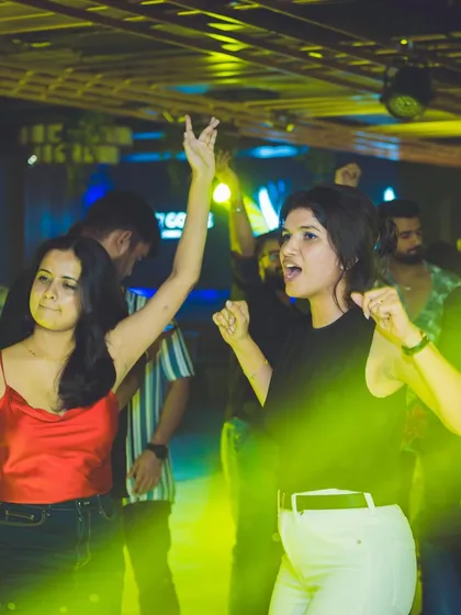 Guests dancing under the yellow lights at Gawky Goose.