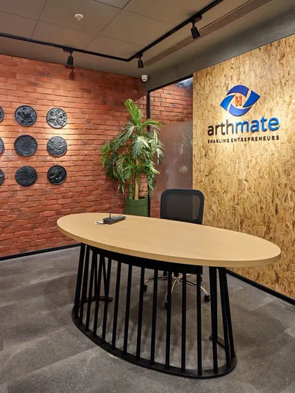 The reception for Arthmate in BKC, Mumbai, has a raw and rustic vibe. We used an exposed brick wall, an OSB panel with the company logo, and a sleek, modern desk to create a space that feels both grounded and entrepreneurial.