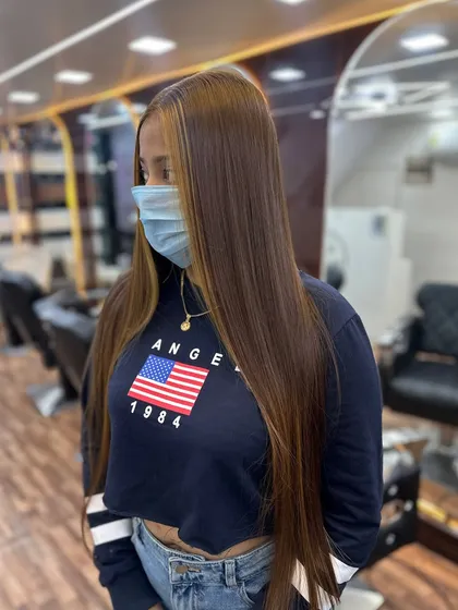 This global hair color with face-framing highlights is sleek, modern, and stylish.