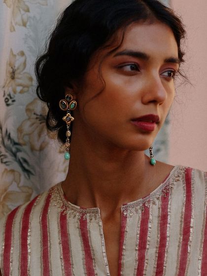 The Azra Drop Earrings add a touch of elegance to this festive striped kurta. The turquoise-hued stones provide a beautiful pop of color, making it a versatile choice for many occasions.