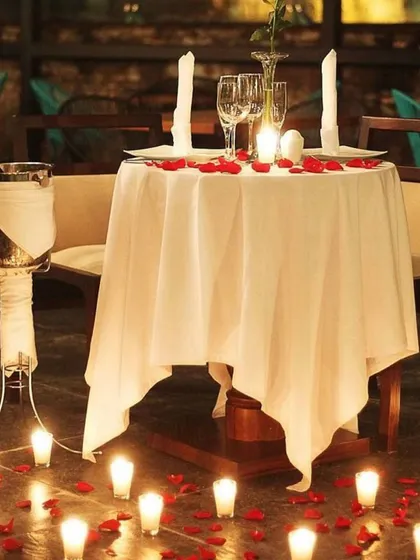 A classic romantic dinner for two. I can set up a private table with a crisp white tablecloth, champagne on ice, and a path of candles to create an exclusive and intimate dining experience.