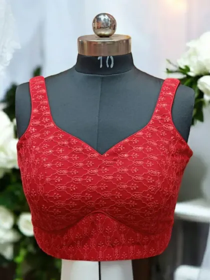 The front of the red lace blouse features a classic sweetheart neckline and delicate floral lace fabric, making it a timelessly beautiful piece.
