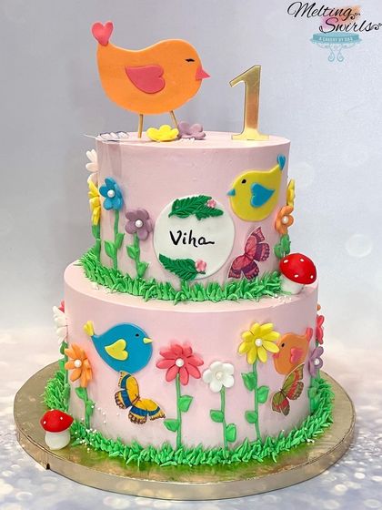 Another beautiful birds and garden themed two-tier cake, showcasing our ability to recreate popular designs with perfection.