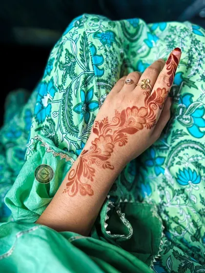 An elegant Arabic-style vine design showing its fresh orange stain.