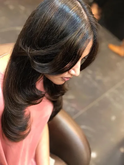 A close-up of face-framing layers, which are designed to soften features and add shape to the front of the hair.