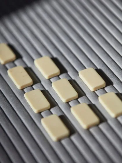 Infusing your spaces with a velvety, architectural elegance. This close-up of a grey, ribbed 3D wallcovering shows how the texture interacts with light, creating a sophisticated and tactile surface.
