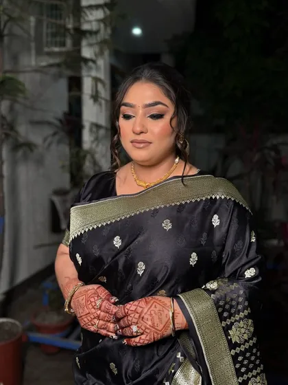 A classic party look featuring a black saree. We created a bold, winged eyeliner and a soft, messy updo to give it a modern and sophisticated feel.