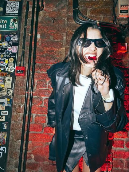 A candid moment from the H&M event against a gritty, industrial brick wall. This shows how I can adapt my style and energy to fit a brand's specific look and feel.