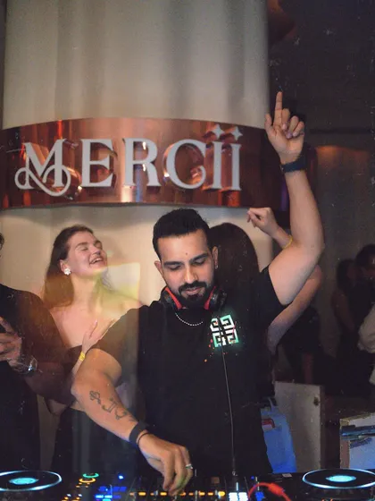Officially accepting the title: Life of the party. A shot of me at Mercii, raising a hand to connect with the crowd.