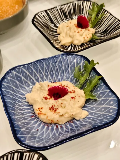 Where tradition meets artistry. Smooth hummus is elevated with a sprinkle of spice and a floral touch that transforms it into a visual delight.