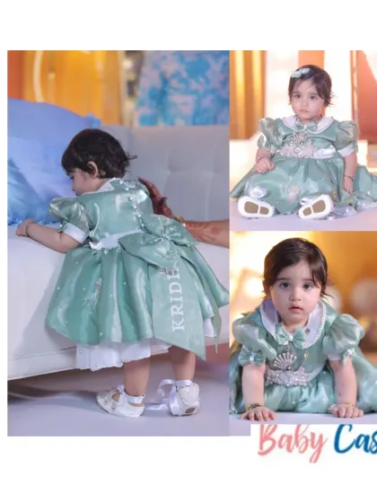 Personalization is at the heart of what we do. This beautiful sage green satin gown was customized with the birthday girl's name, 'KRIDE', embroidered on the back, making her special day outfit a true one-of-a-kind keepsake.