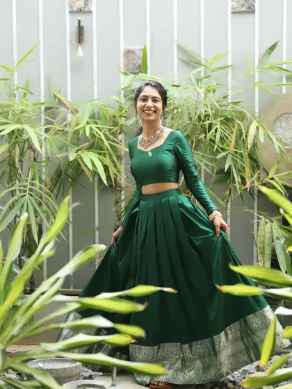 The beautiful Mahima, sister of the bride, ready for a pre-wedding ritual. Her look is fresh and vibrant, with a simple hairstyle and makeup that complements her green outfit.