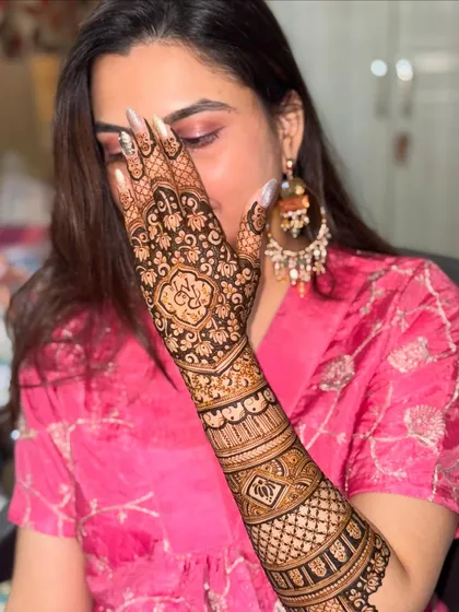 A classic 'peek-a-boo' pose with the beautifully adorned hand. This shot highlights the intricate details of the back-of-hand design.