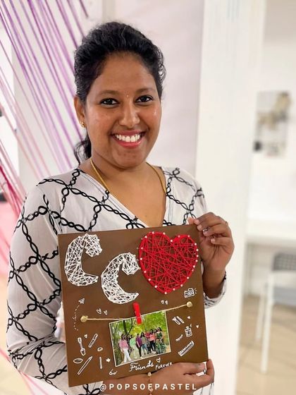 This participant created a personalized string art piece for a friend, complete with initials and a heart.