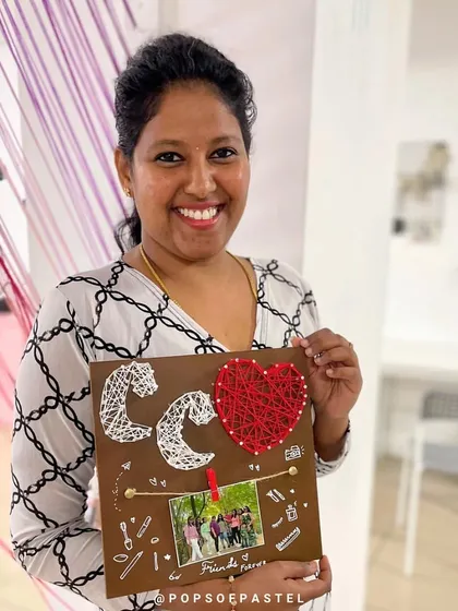 This participant created a personalized string art piece for a friend, complete with initials and a heart.