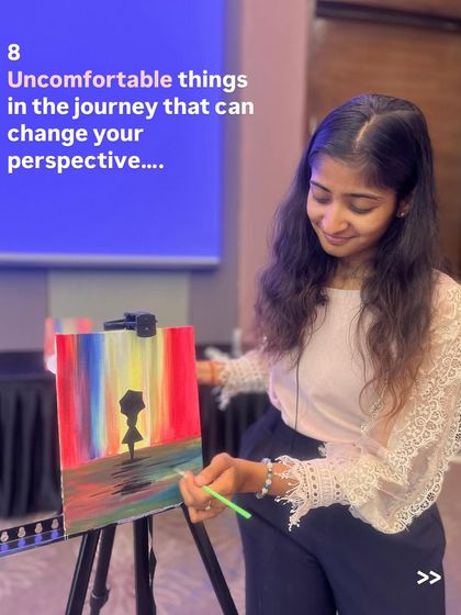 Me, painting a colorful abstract piece during a workshop. I often paint alongside my students to share the creative energy.