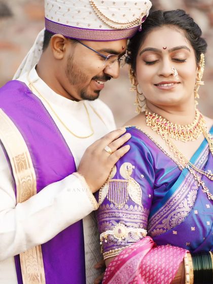 A beautiful portrait showcasing the intricate embroidery on the bride's blouse and the couple's serene expressions.