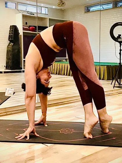 A variation of a standing forward bend on tiptoes, this pose challenges balance and strength. It reflects 'Ikigai,' our reason for being, as we reach higher while staying rooted.