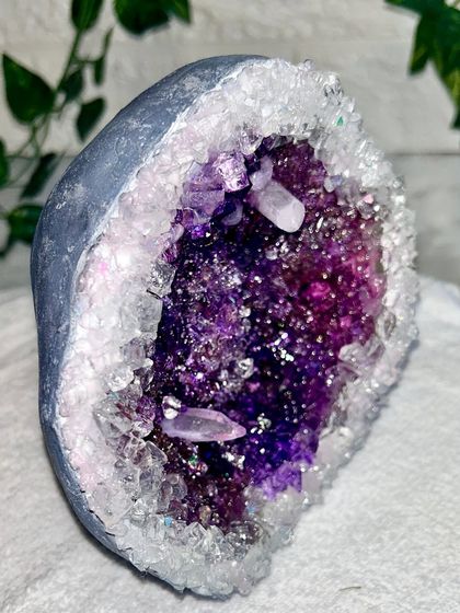 A side view of the geode, showing the depth of the crystals and the carefully painted outer rock.
