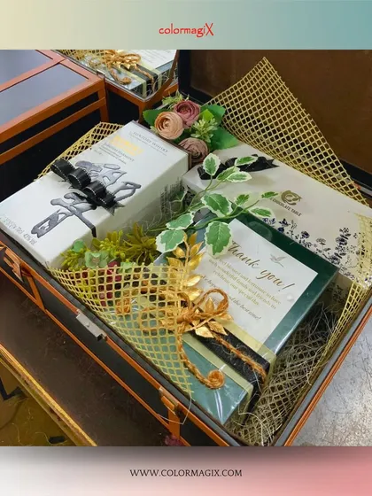 A close-up of the contents within our leather suitcase hamper, showing the thoughtful arrangement of gifts, floral accents, and a personalized note.