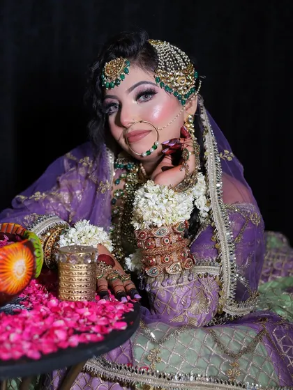 A regal pose in the mint green and lavender lehenga. The passa and floral hair accessories add a touch of Mughal-inspired elegance.