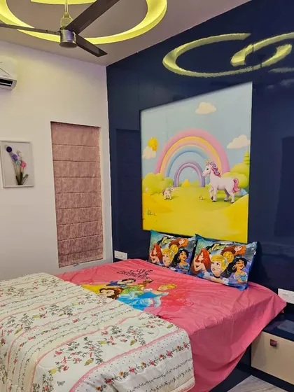 This child's room features a magical unicorn and rainbow mural above the bed. The bright, happy colors create a cheerful atmosphere perfect for a young dreamer.