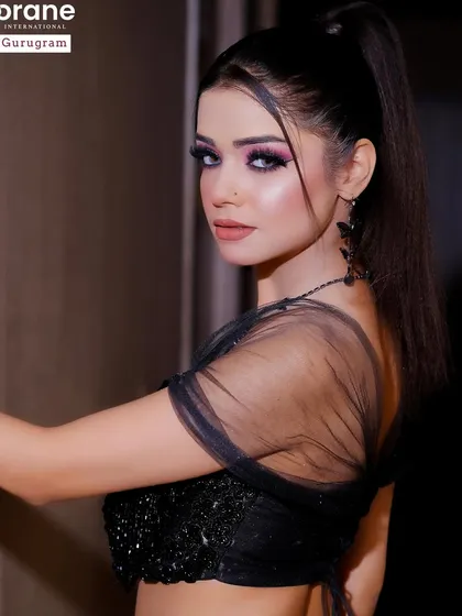 This black and white themed look is all about drama and elegance. The sharp, graphic eye makeup and high ponytail are techniques I cover in my high fashion makeup classes.