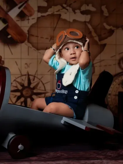 Adjusting his pilot goggles before takeoff. The details in our props and costumes make our travel-themed shoots extra special.