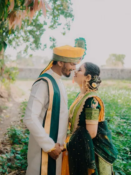 A romantic profile shot of the couple about to share a kiss. The soft light and natural setting create a dreamy and intimate atmosphere.