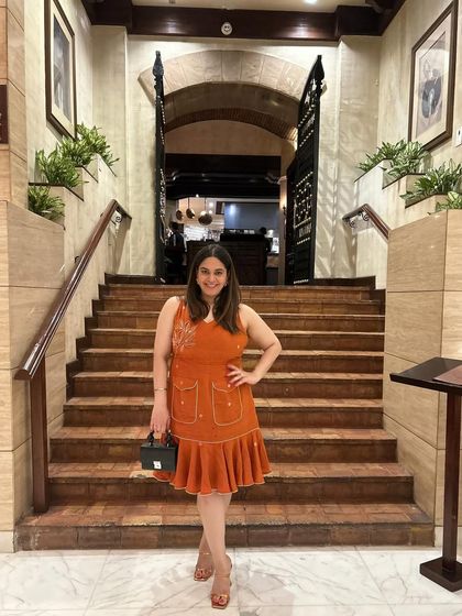 Wearing a beautiful tangerine fluted dress by Tilsim by Sagarika for a dinner at La Piazza. The color and silhouette were perfect for a summer evening at an iconic Italian restaurant.