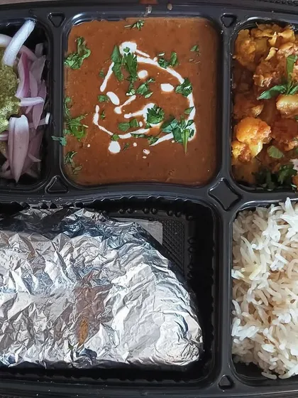 This is a look at one of my classic home-style thalis. It features my special Dal Makhni, a simple Aloo Gobi sabzi, fluffy rice, soft rotis, and a fresh salad. It’s a complete, wholesome meal that will remind you of home.