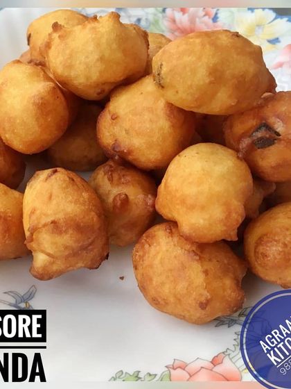 A pile of fluffy Mysore Bondas, golden brown and ready to be enjoyed. These savory dumplings are soft on the inside and slightly crisp on the outside.