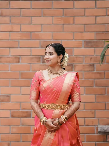 A full view of Ruchira's timeless muhurtha look. My focus was on creating a flawless base that looked like real skin, paired with classic eye makeup that enhanced her features without overpowering them.