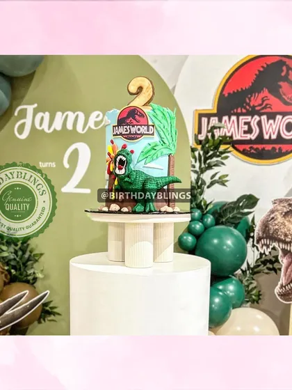 A close-up of the Jurassic World cake, featuring a dinosaur topper.