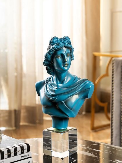 This Greek god bust in a striking teal blue offers a modern twist on a classical subject. Mounted on a clear acrylic base, it adds a pop of color and a touch of historical art to a contemporary space.