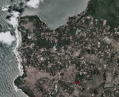 A satellite view marking the location of the Vagator Villas project in Goa. The masterplan organizes the villas in a compact cluster, preserving the surrounding green cover.