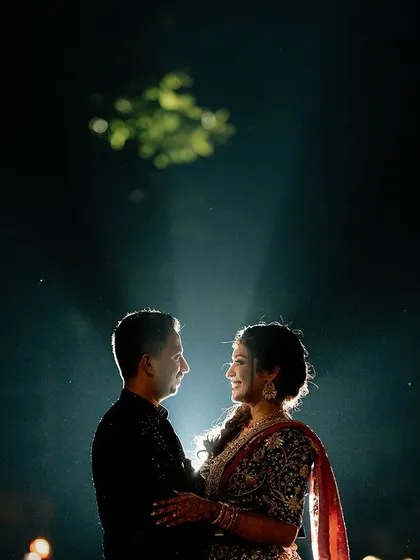 We love playing with light to create something magical. This dramatic spotlight shot during a night session highlights the couple, creating an intimate and artistic portrait that feels like a scene from a movie.