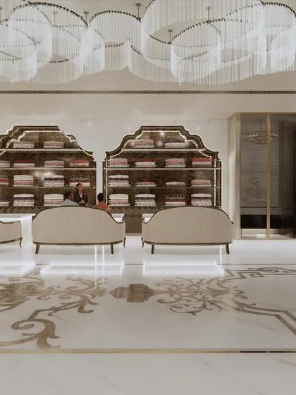 A frontal view of the main showroom floor at Frontier Bazaar. The symmetrical arrangement of seating and display shelves, illuminated by a series of grand chandeliers, creates a sense of balance and regal order.