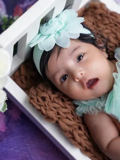 Another angle from the crib setup, this shot shows her looking curiously at the camera, a precious memory for her parents.