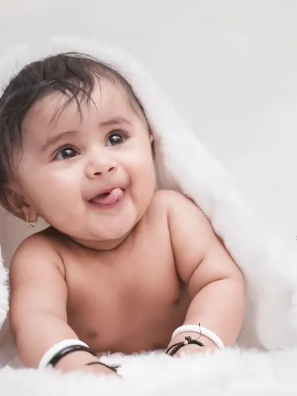 A cheeky little tongue-out moment from a three-month-old baby. We are always ready to capture these fleeting, funny expressions.