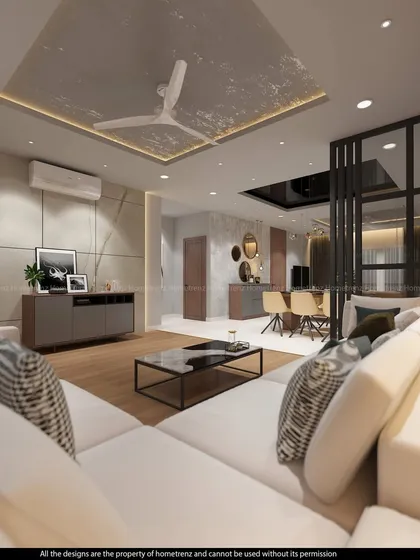A bright, open-concept drawing room with a large white sofa and wood flooring. The textured ceiling panel and open partition add architectural interest to the minimalist design.