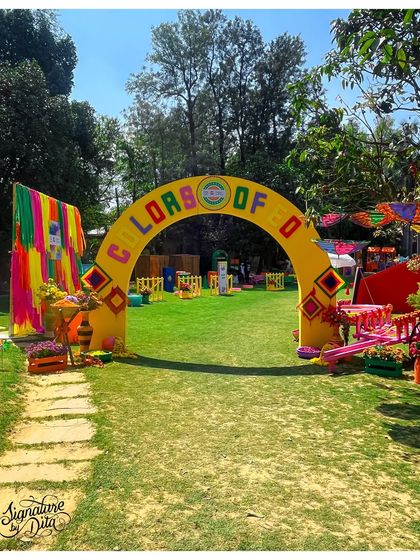 A wider view of the "Colors of EO" entrance arch, showing how it frames the entire festival ground. A strong entrance is crucial for making a great first impression.
