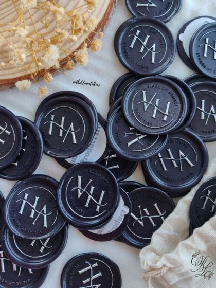 A closer look at the custom "VH" monogram wax seals, ready to be applied to the anniversary invitations.