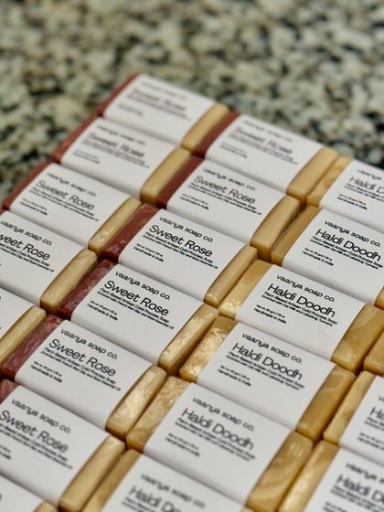 Another shot of the beautifully labeled Haldi Doodh and Sweet Rose soaps. We ensure every detail is perfect for your event.