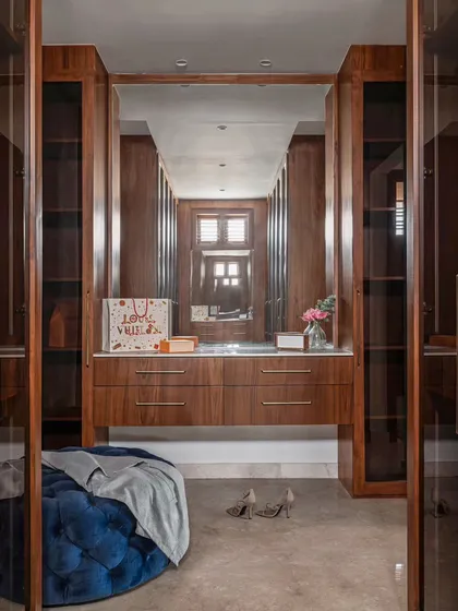 A well-organized walk-in closet can be a total game-changer. This space was designed to be both beautiful and highly functional, with custom cabinetry, a central ottoman, and great lighting to make getting ready a pleasure.