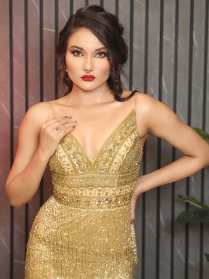 A mid-shot capturing the essence of this cocktail party makeup. The focus is on the flawless skin and the striking red lip, creating a look that is both elegant and powerful.